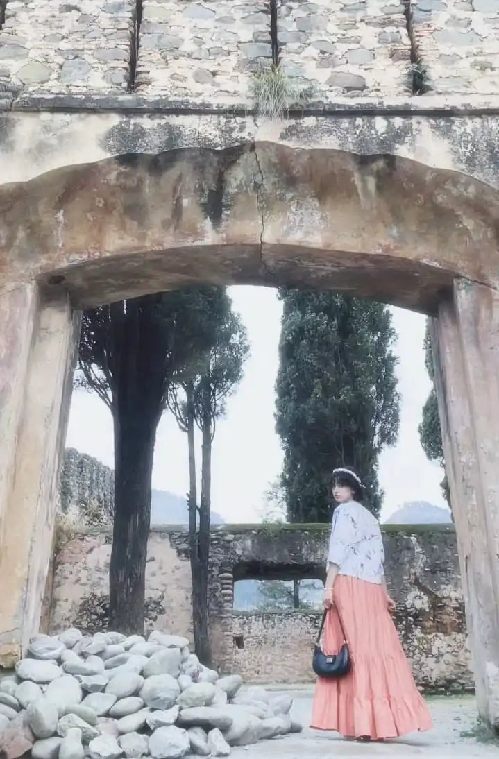 Women wearing a light-colored cotton printed fusion shirt paired with a long skirt