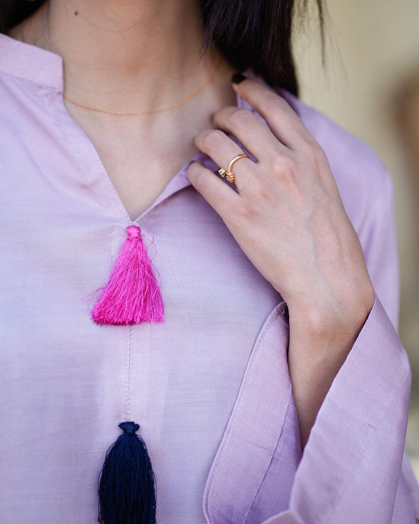 Close up of v-neck line of lilac dress.