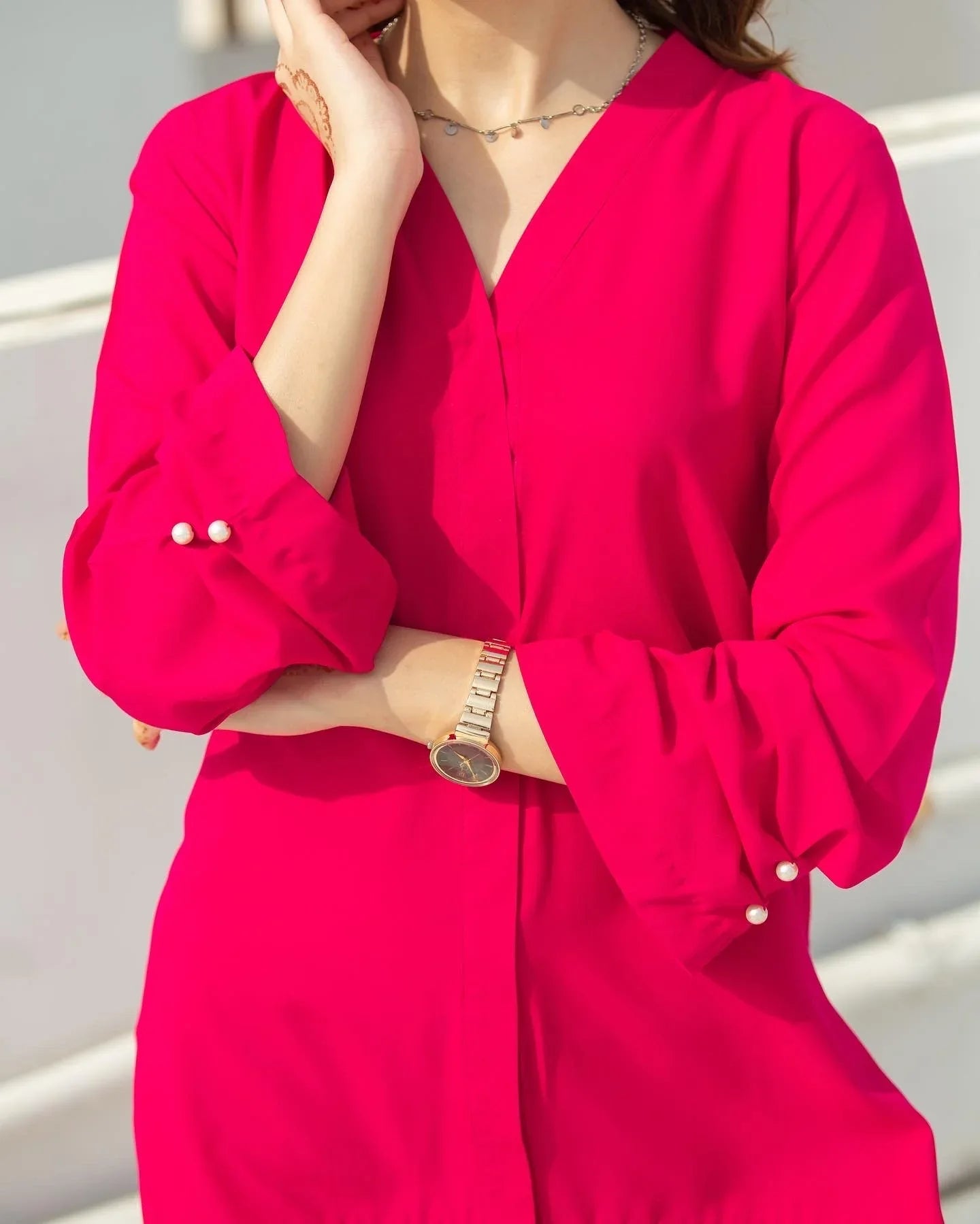 Close up on the women wearing a  pink top.