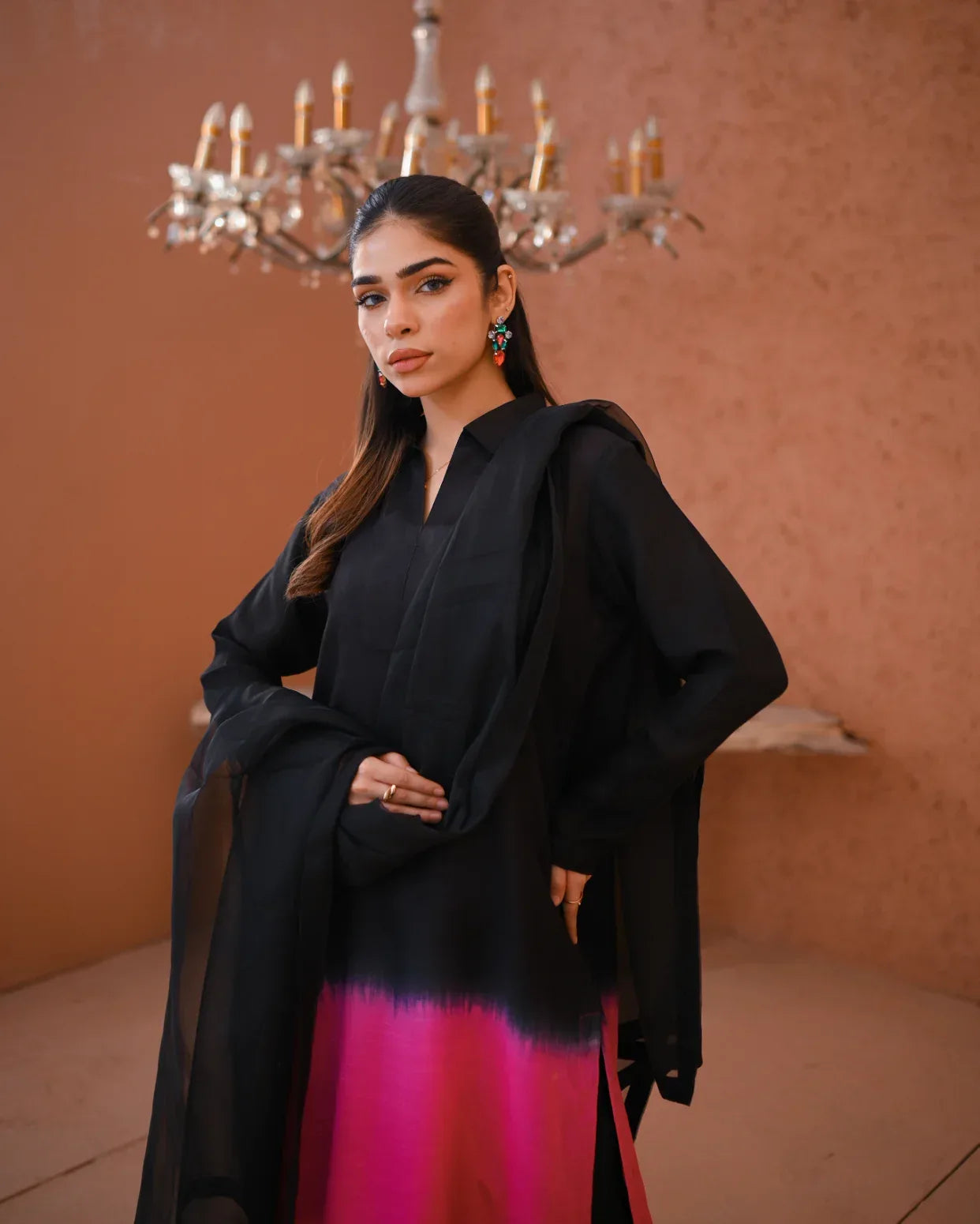 A woman wearing a three piece rawsilk dress ombre shirt and an organza dupatta.