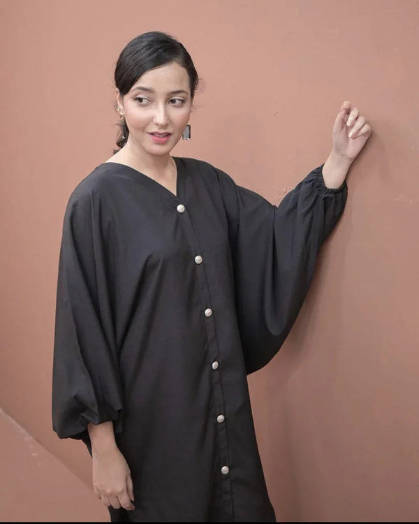 A women wearing a two piece charcoal black dress.