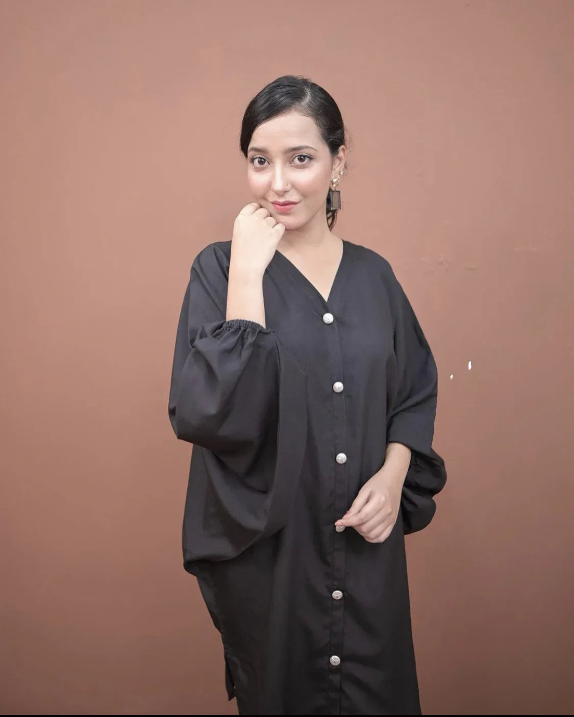 A women wearing a two piece charcoal black dress.