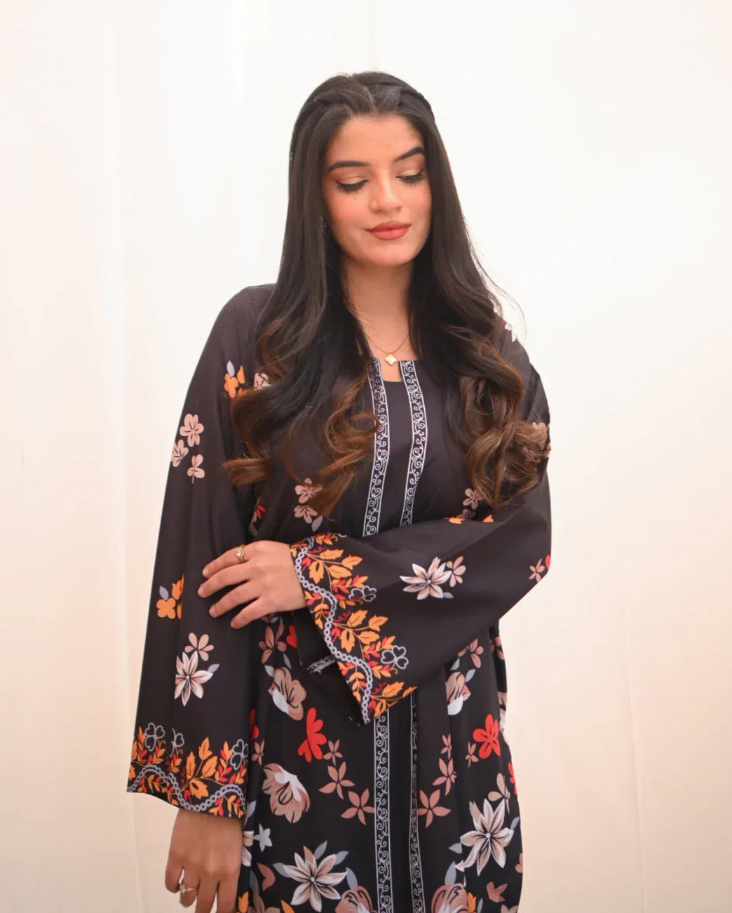 Women wearing a printed black two piece dress.
