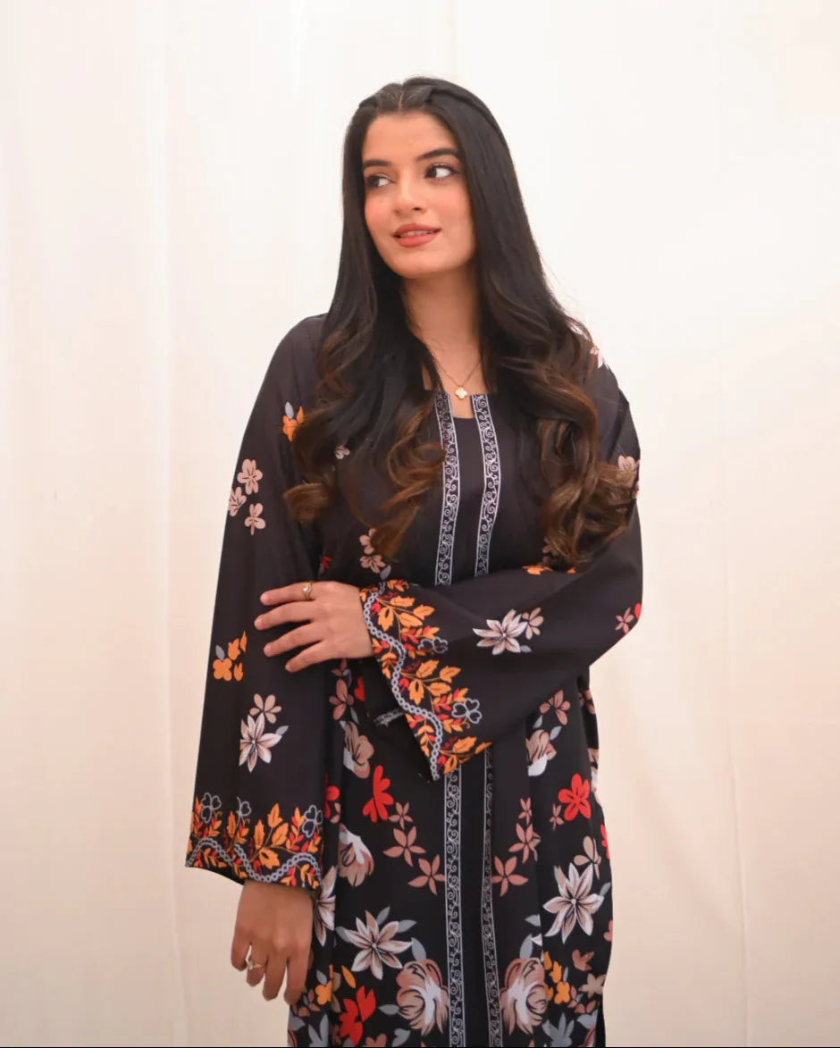Women wearing a printed black two piece dress.