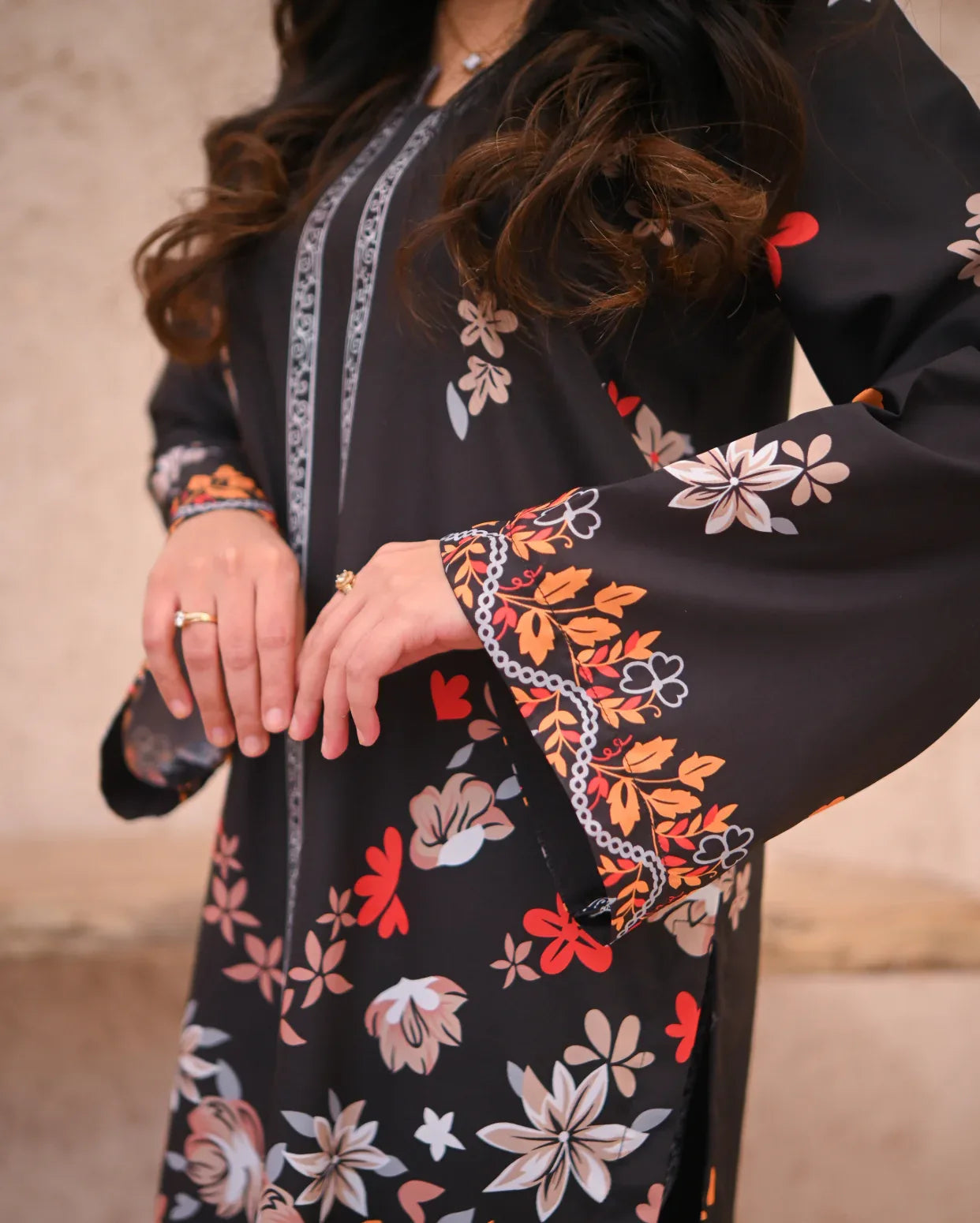 Close up of the details of Women wearing a printed black two piece dress.