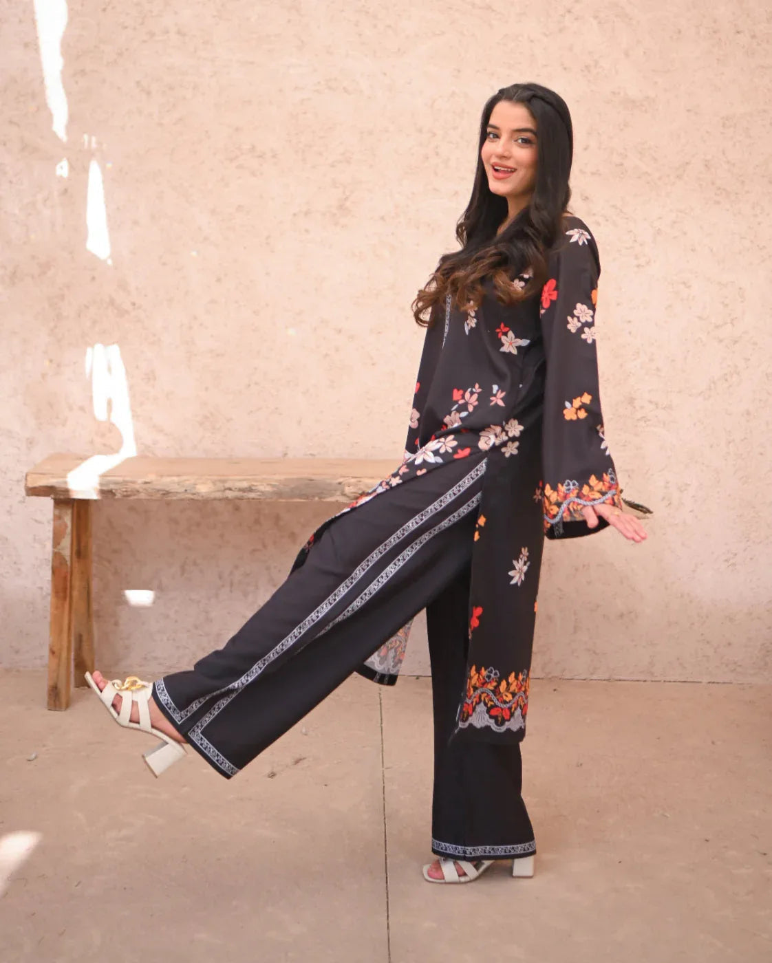 Women wearing a printed black two piece dress.