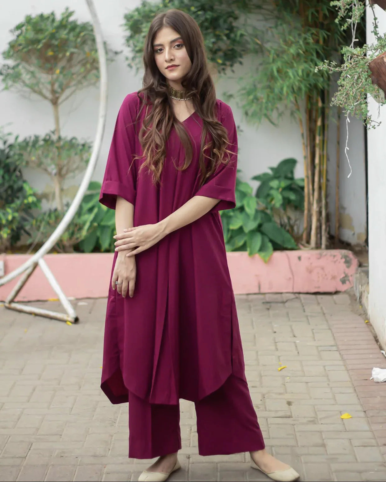 A woman wearing a marjanda color stitched dress standing confidently, showcasing her stylish outfit.