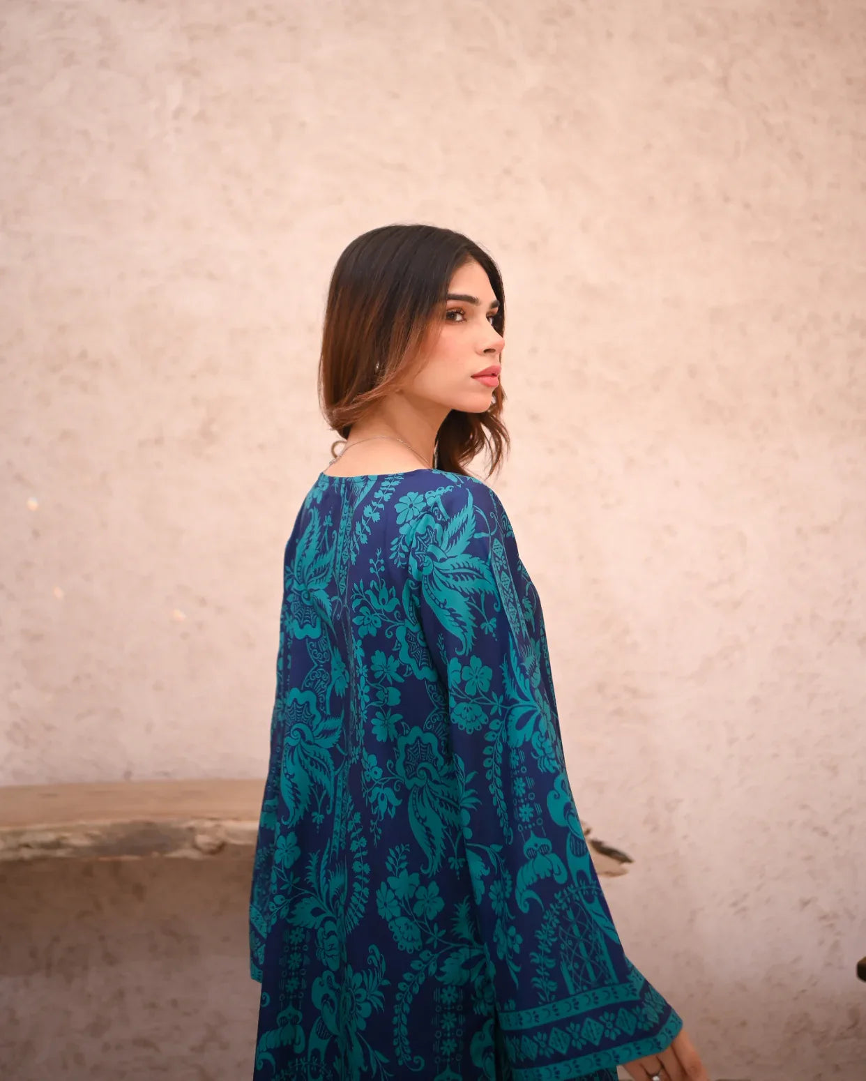 Women wearing a floral printed two piece dress which includes a shirt and culotte.