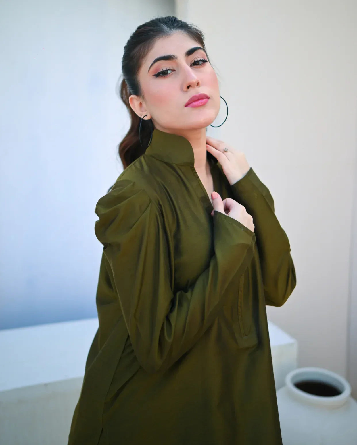 Woman wearing a green dress with a blurred background