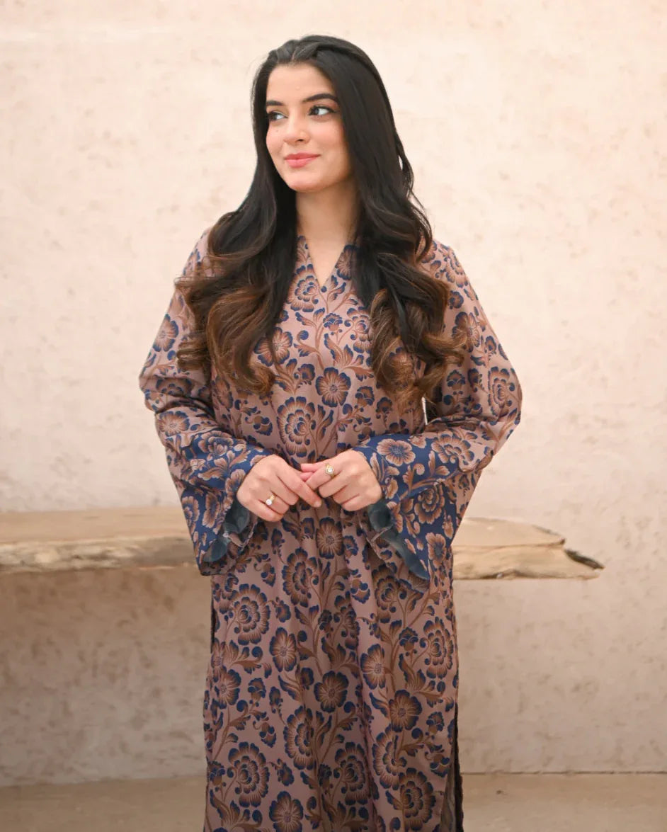 A Women wearing a printed brown and navy blue color two piece dress . Print is floral.