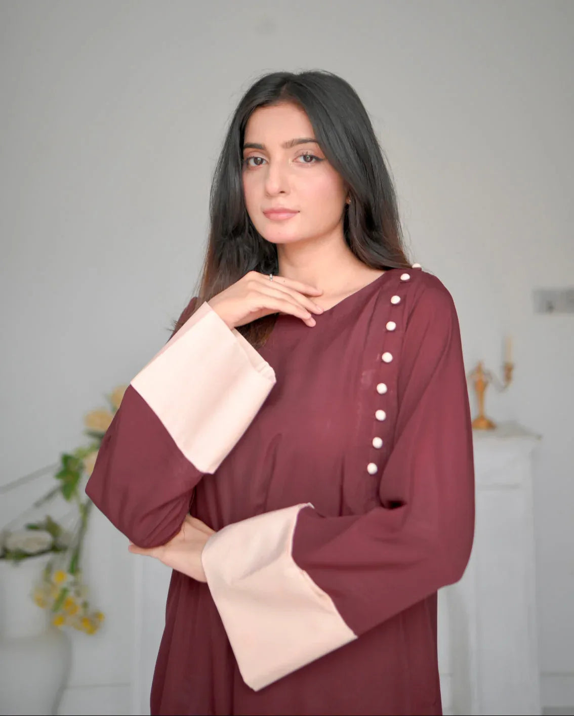 Women wearing a maroon two piece dress with phone color borders on sleeves.