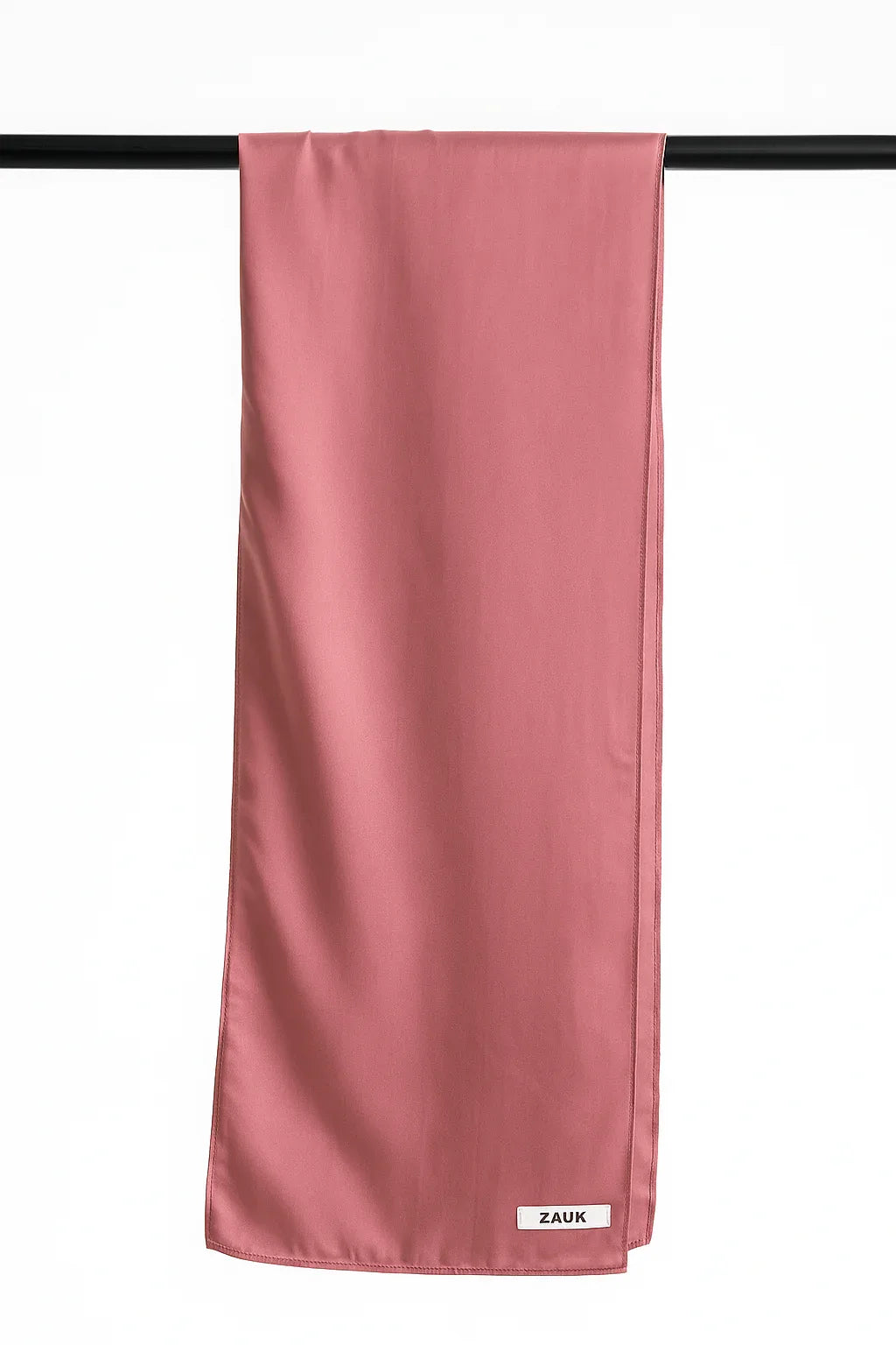 Tea Pink scarf hanging on a black bar with 'ZAUK' branding.